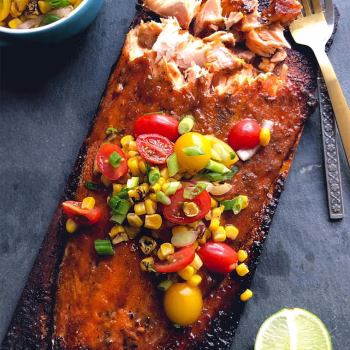a sumptuous grilled salmon plate covered in delectable garnishes